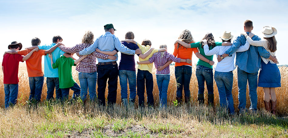 We understand FAMILY better than anyone! photo of a family connected in a line after sponsoring family members to immigrate to Canada
