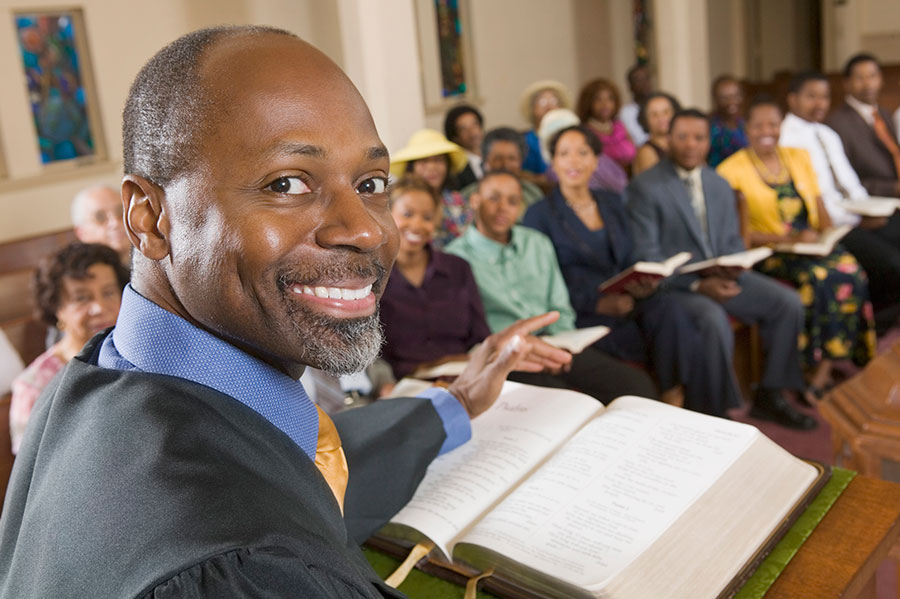 photo of a religious worker addressing a group of people at church, a position exempt from requiring an LMIA to work in Canada