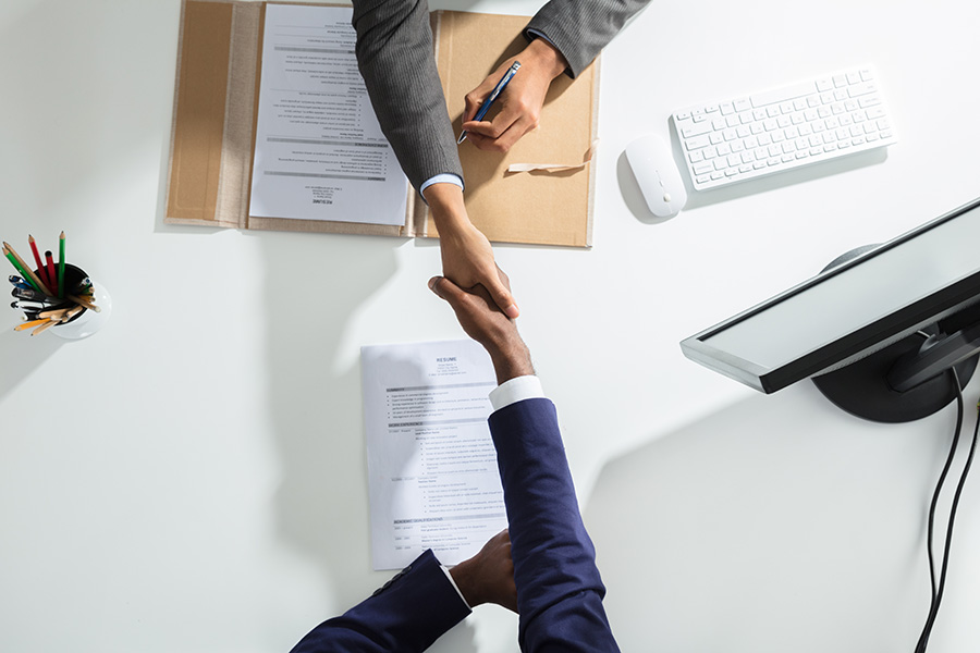 photo of two men shaking hands; a foreign worker approved for working in Canada